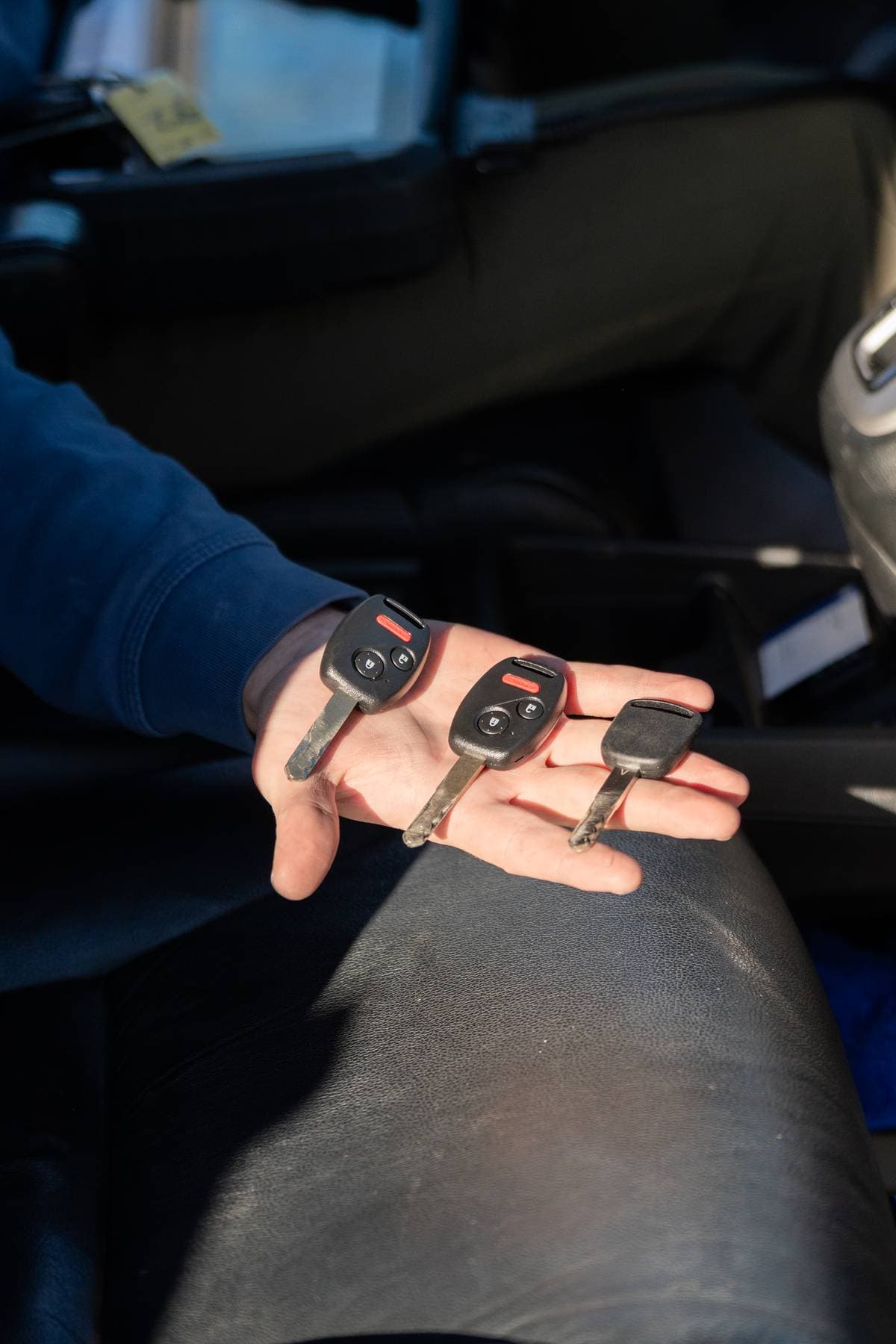 Image of 3 car keys in the palm of a person's hand